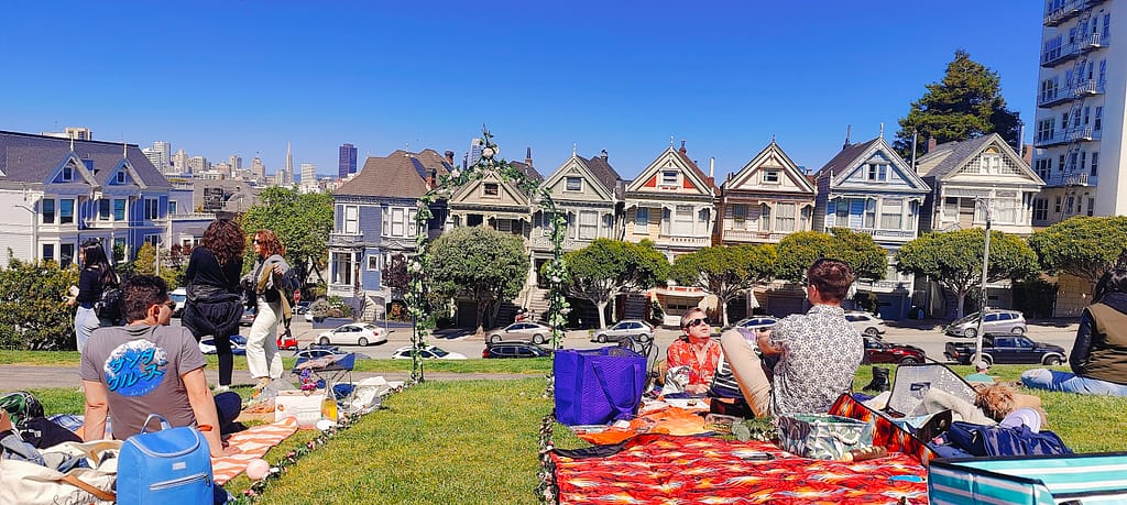 A view of a flower runway with the Painted Ladies of San Francisco in the background.